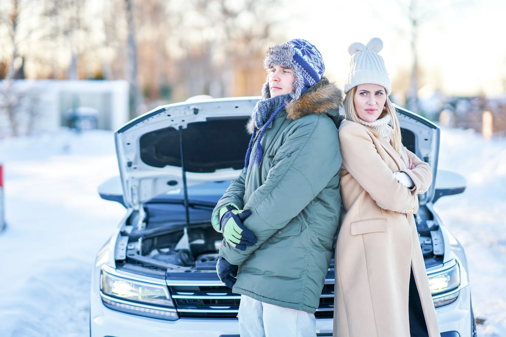 Couple having problem with the car during winter trip